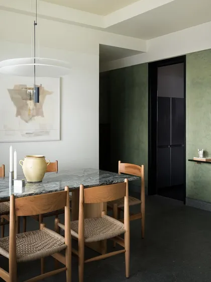 The dining space at the Barefoot House, featuring a custom oak table and chairs against a deep green wall. This project demonstrates my approach to creating enveloping, atmospheric spaces for living.
