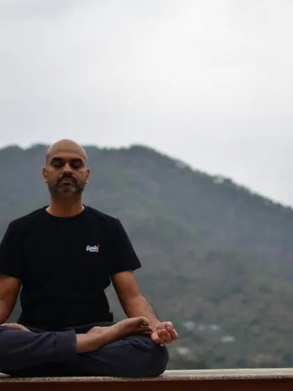 A moment of deep meditation in Padmasana (Lotus Pose). The serene environment of the Himalayas is highly conducive to turning the senses inward and finding inner stillness.