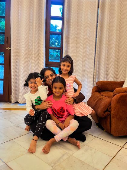 A quiet moment of connection between a teacher and her students after class.