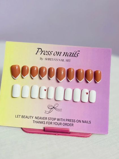 Sometimes simple is best. Here are two minimalist sets, one in a warm terracotta with a V-French tip and another in pure white with a tiny heart accent, perfect for everyday glam.