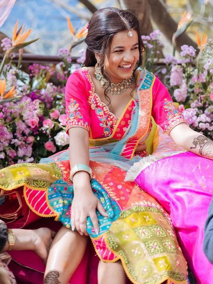 A bride's radiant smile during her colorful Mehendi ceremony in Jim Corbett, a picture of pure happiness.