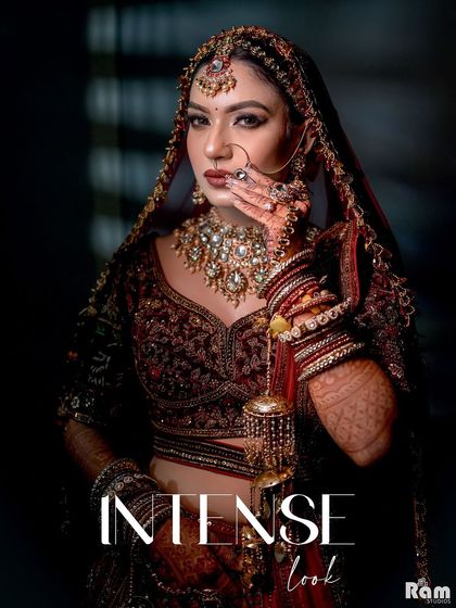 An "Intense Look" from a bride. This close-up portrait uses dramatic lighting to highlight her bold makeup, stunning jewelry, and confident expression, creating a powerful and captivating image.