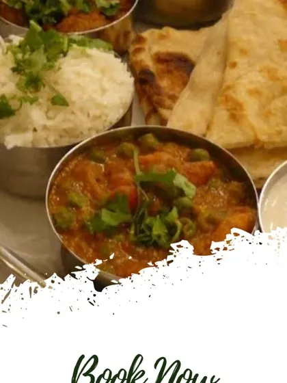 A perfect meal for a special occasion or a weekend treat. This thali includes a rich mix vegetable curry, fluffy rice, and soft naan, showing the variety available beyond our daily tiffin.