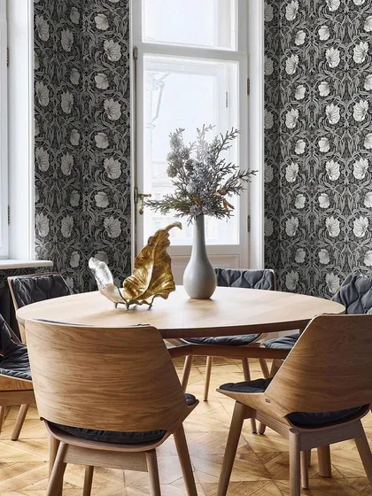 A dining room featuring a classic Arts & Crafts inspired design from our Heritage Prints collection. The black and white colorway gives the traditional pattern a modern, graphic edge that is both bold and elegant.