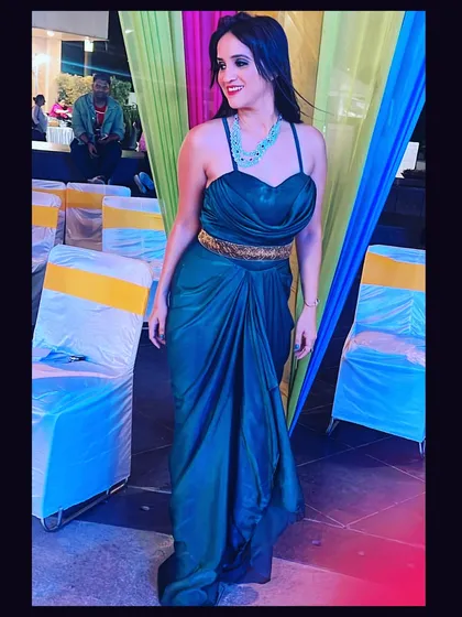 A beautiful teal gown styled for a wedding celebration. The draped silhouette and elegant color were chosen to flatter the body and create a sophisticated look, perfect for any formal Indian function.
