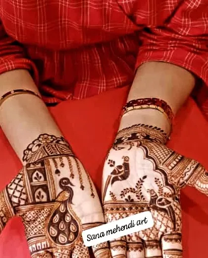 A beautiful Teej design with peacocks in a window frame.