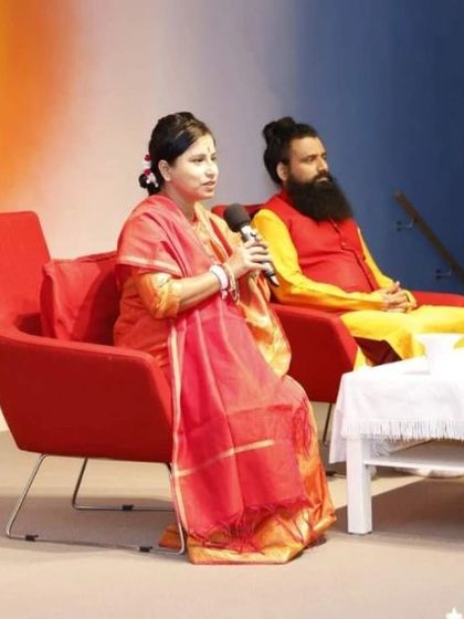 Maa Aditiji speaking at the Sydney event. This photo, similar to others from the event, captures her in a moment of sharing deep spiritual insights.