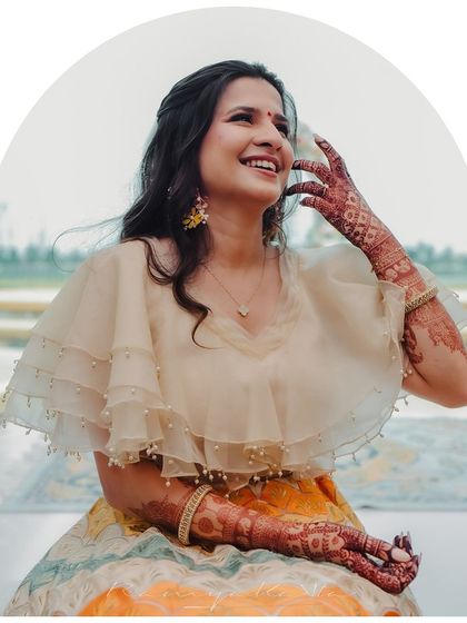 The complete look, radiating happiness and effortless style. The intricate henna design complements the festive feel of the custom lehenga.