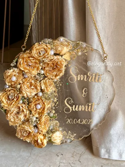 Another beautiful example of a wall-hanging varmala preservation frame. The golden roses are clustered on one side, creating a stunning 3D effect.