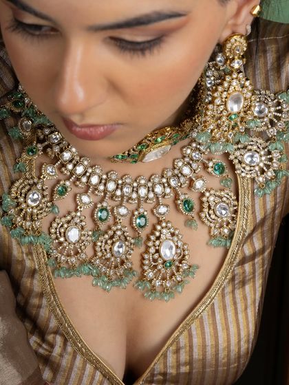 Another angle of the regal Kundan bridal set, focusing on the stunning detail of the choker and the large, ornate earrings. This is a piece designed to be the centerpiece of a bridal outfit.