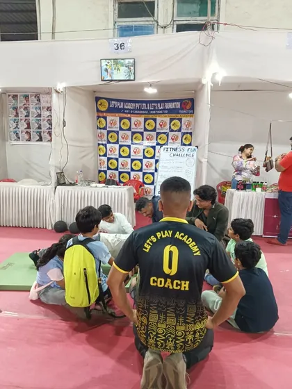 Our coach guiding participants through a fitness challenge at our community fiesta stall. We provide on-the-spot coaching to ensure everyone can participate safely.