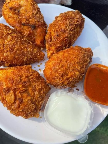 For a modern twist, I make these Kurkure Momos. Steamed dumplings are coated in a crunchy batter and deep-fried until golden. They offer a unique texture and are served with mayonnaise and a spicy momo chutney.