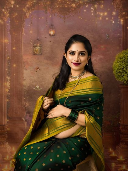 A seated portrait that exudes grace and serenity. The mother-to-be, dressed in a traditional green and gold saree, is the picture of maternal beauty.