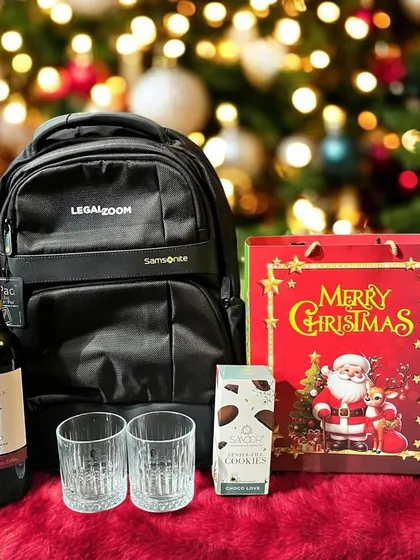 A Christmas-themed corporate gift for the employees at LegalZoom. This festive set includes a Samsonite backpack, a bottle of wine, whiskey glasses, and cookies.
