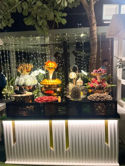 The fruit counter at night, with fairy lights adding a magical sparkle to the delicious spread.