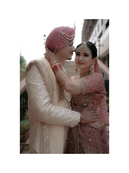 An intimate close-up of the couple, the bride gently touching the groom's face, a tender and loving gesture.