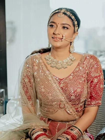 A moment of quiet reflection before the ceremony. The natural light catches the subtle glow on her skin, showcasing a natural yet polished bridal look that feels effortlessly beautiful.