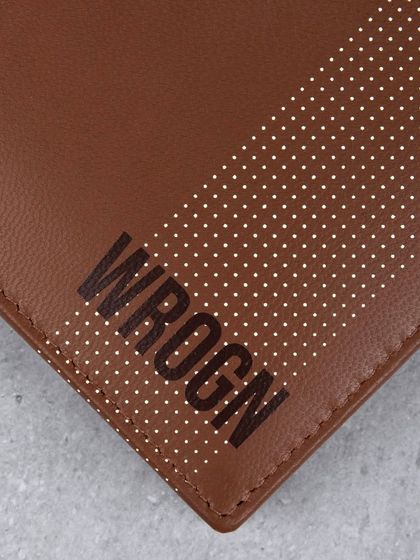 A close-up of the dotted pattern and logo on the brown 'WROGN' wallet.