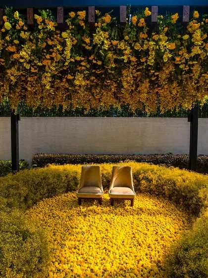 An intimate Haldi ceremony I designed during the pandemic. The couple is seated amidst a sea of bright yellow marigolds, creating a circle of sunshine and positivity.