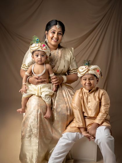 A mother with her two sons, all dressed as little Krishnas. A beautiful and unique family portrait.