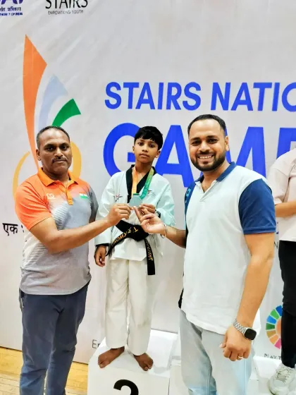 A young black belt student receiving his silver medal at the Stairs National Games. We nurture talent from a young age to build future national champions.