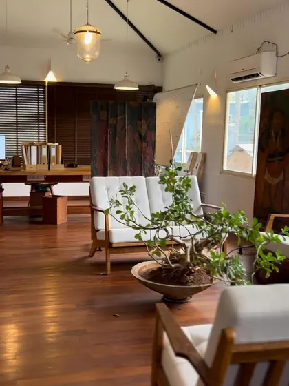 The lounge area of our Goa studio, featuring a bonsai tree and comfortable seating. It's a space for creative discussion and welcoming clients.