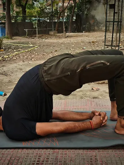 Here I am demonstrating Setu Bandhasana, or Bridge Pose. This asana gives a good stretch to the chest, neck, and spine, and is beneficial for opening up the lungs and improving digestion.