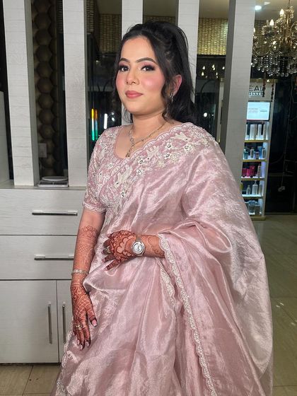 Another angle of this gorgeous party look. The high ponytail and soft pink makeup create a chic and modern style.