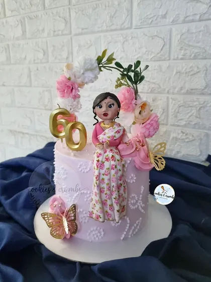 It's the best feeling to see my cake become a part of such a happy moment. I created this custom miniature doll cake for a 60th birthday, matching the fondant figure's saree to the birthday girl's actual outfit.