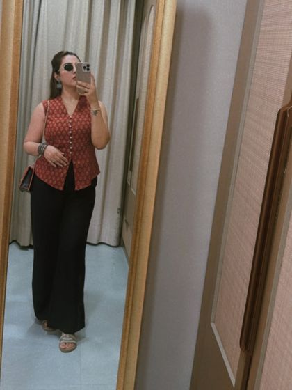 Another shot of the waistcoat look, proving its versatility. The red and black combination is a timeless classic, while the modern silhouette keeps it fresh and contemporary.