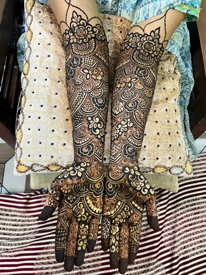 Another view of Muskan's bridal mehndi, showing the symmetry and complexity of the design on both arms.