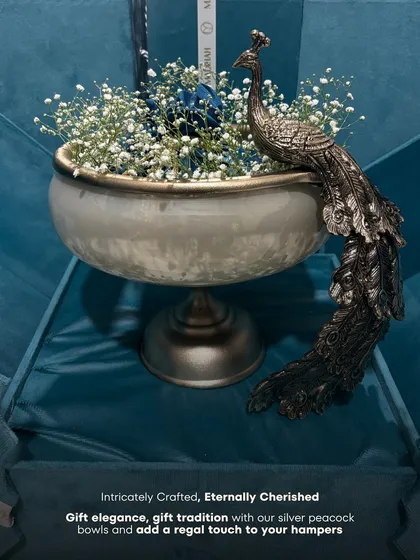 "Intricately Crafted, Eternally Cherished." This image captures the essence of our silver peacock bowls, designed to add a regal touch to any hamper or home.