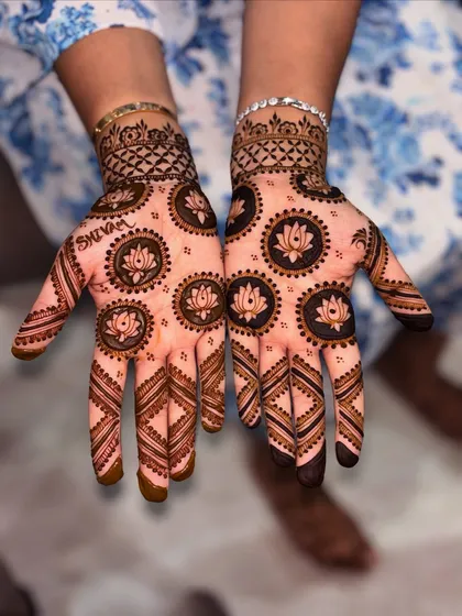 A popular choice for Rakshabandhan, this design features matching lotus mandalas on both palms. I can also personalize your mehndi by hiding a name within the pattern, like the name "Shivam" you see here.