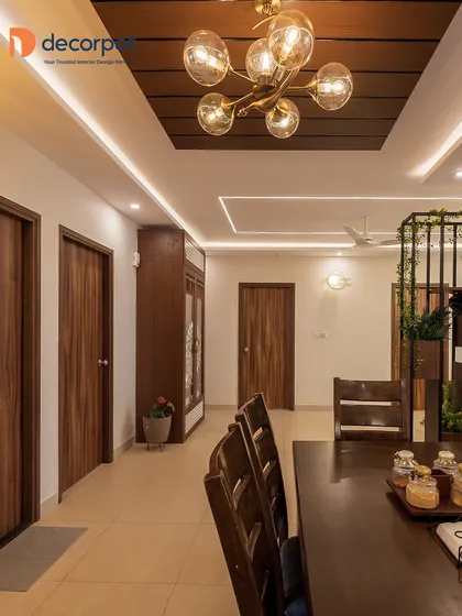 This dining area is designed with a touch of rustic elegance, featuring a solid wood dining table and a beautiful glass bubble chandelier. The open layout connects seamlessly with the rest of the home.