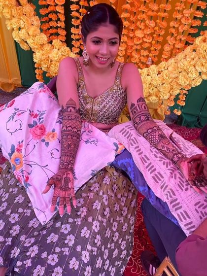 Another angle of the application process, capturing the artist's focus and the bride's happy anticipation.