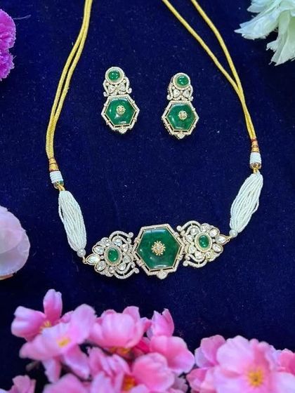 The beautiful green enamel choker set with matching earrings. The pearl strands add a touch of softness to this statement piece.