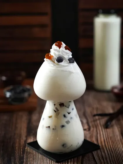 A whimsical mushroom-shaped glass filled with boba tea, topped with whipped cream and caramel. The dark, woody background creates a moody and indulgent feel, perfect for a specialty drink menu.