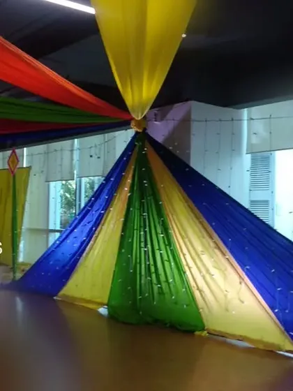 Creating a festive canopy with colorful drapes for a Dandiya Night. This technique instantly transforms a space and adds to the celebratory energy.