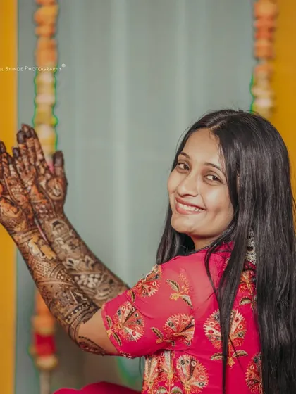 A happy bride showing off her beautiful, dark henna stain. Seeing my clients this happy is the best part of my job.