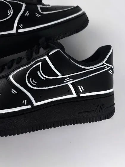 A detailed shot of the white outlines on the black cartoon custom sneaker.