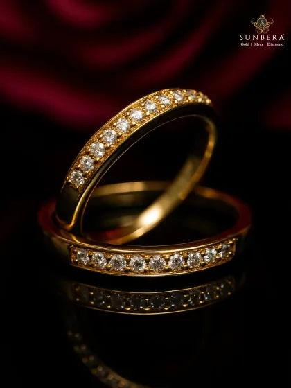A pair of classic gold and diamond eternity bands. These rings are a timeless investment, perfect for wedding bands, anniversary gifts, or stacking, showcasing our precision in stone setting.