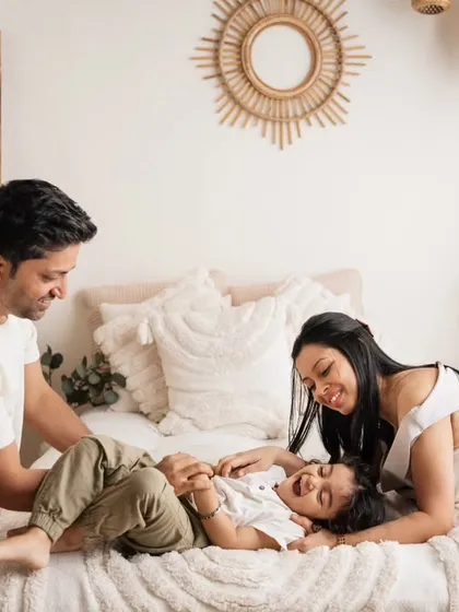 A tickle fight on the bed! My boho studio setup is perfect for these relaxed, lifestyle family photos that capture genuine laughter and fun.