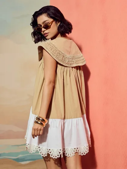 A look from Qala Clothing's "Casa Solana" collection, shot against a custom-painted beach backdrop to create a dreamy, vacation-like setting.