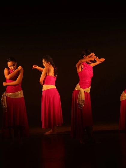 A powerful stage moment with four dancers in red, captured during one of our student showcases. The lighting and emotion convey the intensity of the performance.