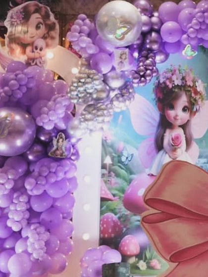 A closer look at the details of our purple fairy theme. The setup features dense balloon clusters, character cutouts, and a large decorative bow, all coming together to create a rich and immersive party environment.