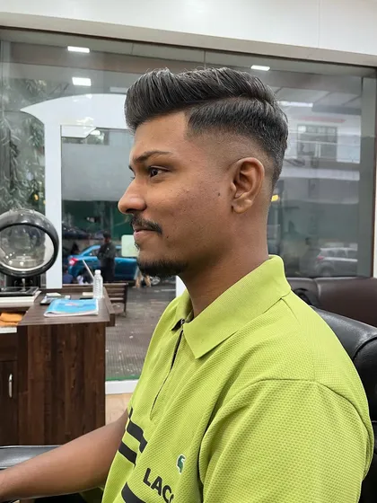 This client wanted a fresh, stylish look. I gave him a high-volume pompadour with a clean skin fade, a popular choice for a bold and modern hairstyle.