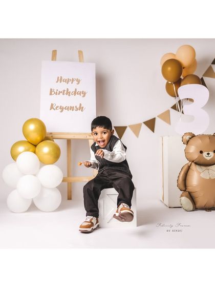 A sweet treat for the birthday boy! This three-year-old is enjoying a lollipop during his teddy bear themed photoshoot.