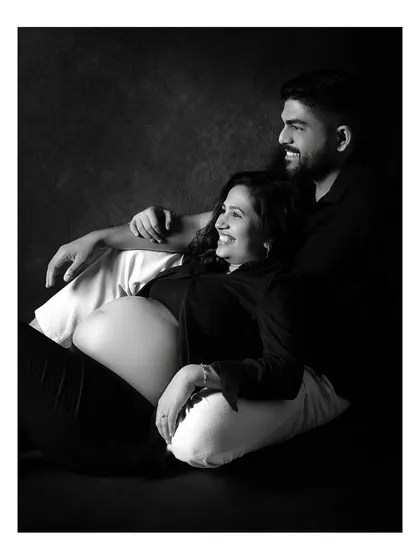 A classic black and white couple portrait that focuses purely on connection and anticipation. By removing color, we emphasize the emotion and the beautiful shape of the baby bump.