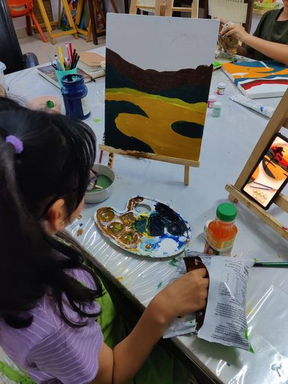 Scenes from our kids' acrylic workshop, where students learn to create bold and colorful landscape paintings.