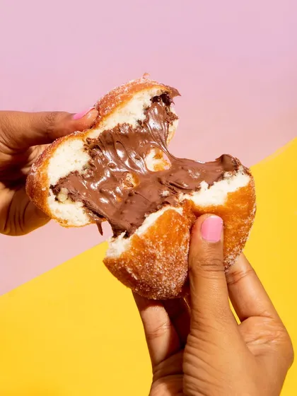 Get ready to drool over this Nutella Stuffed Donut. I make these bombolonis fresh, rolling them in sugar and filling them until they are bursting with gooey Nutella. It's pure indulgence.